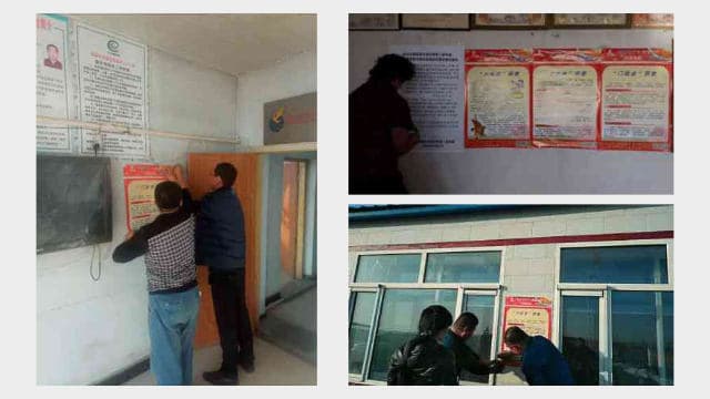 촌(村)위원회 사무실 벽에 반종교 포스터를 붙이고 있는 정부 관리들